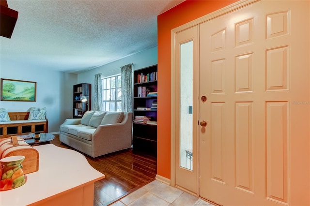 foyer featuring light hardwood / wood-style floors and a textured ceiling