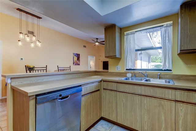 kitchen with sink, hanging light fixtures, stainless steel dishwasher, light tile patterned floors, and kitchen peninsula