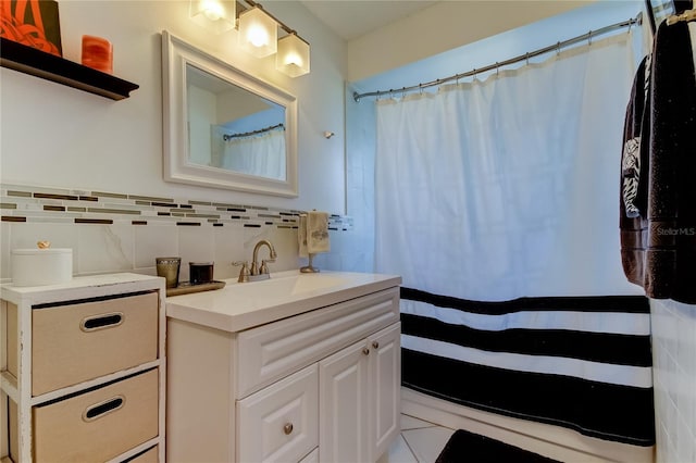 bathroom with tile patterned flooring, vanity, and tile walls