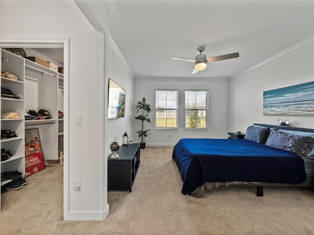 bedroom with carpet, ceiling fan, and ornamental molding