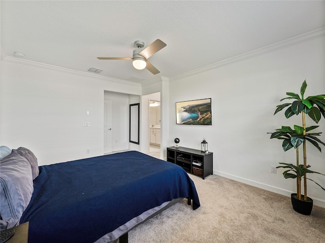 bedroom featuring ceiling fan, crown molding, ensuite bathroom, and light carpet