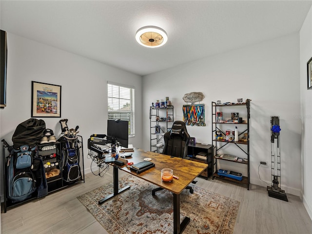 office with light wood-type flooring