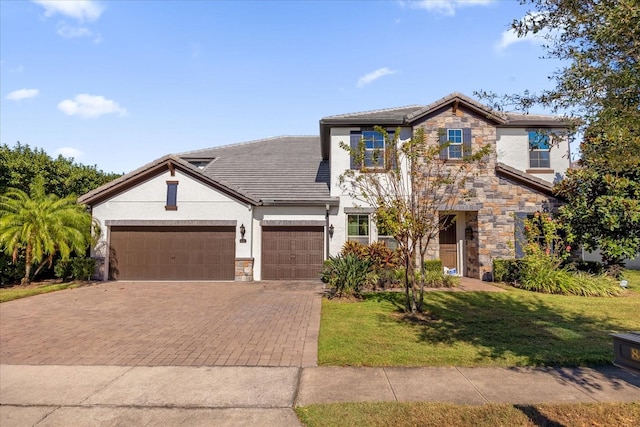 view of front of house featuring a garage and a front lawn