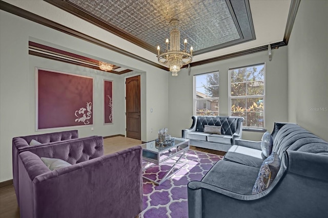 living room with crown molding, wood-type flooring, and an inviting chandelier