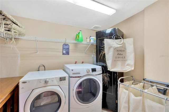 clothes washing area with washing machine and clothes dryer