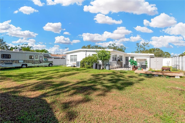 rear view of property with a yard and a patio