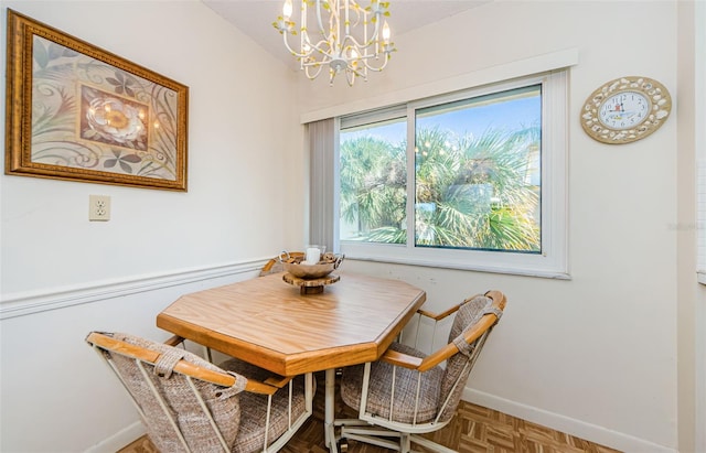 dining space featuring parquet floors and a chandelier