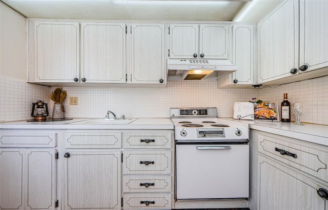 kitchen with electric range, sink, white cabinetry, and backsplash