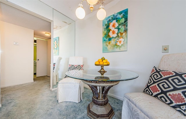 carpeted dining room with an inviting chandelier