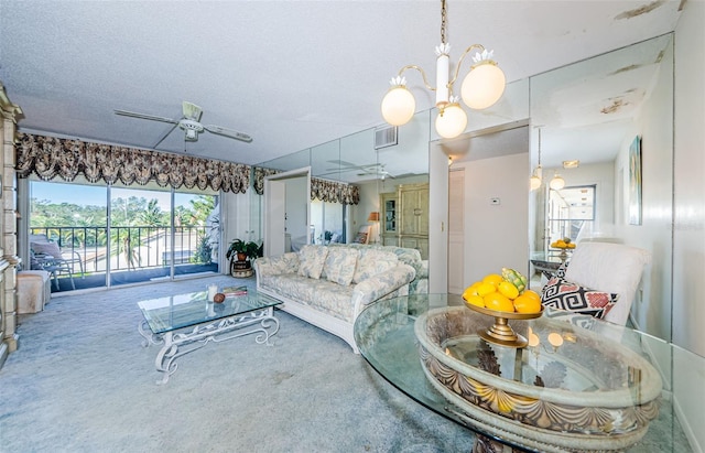 living room featuring ceiling fan with notable chandelier, carpet, and a textured ceiling