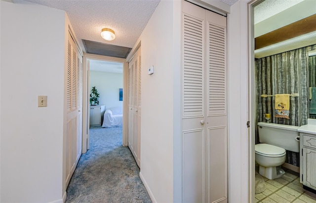 corridor with a textured ceiling