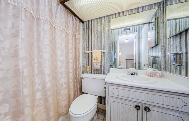 bathroom with tile patterned floors, vanity, and toilet