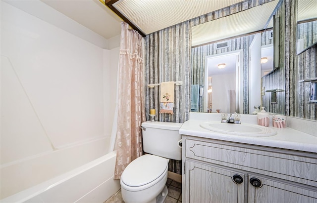 full bathroom featuring tile patterned flooring, vanity, toilet, and shower / bath combo with shower curtain