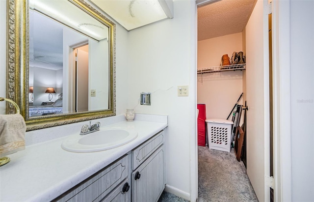 bathroom with vanity and a textured ceiling