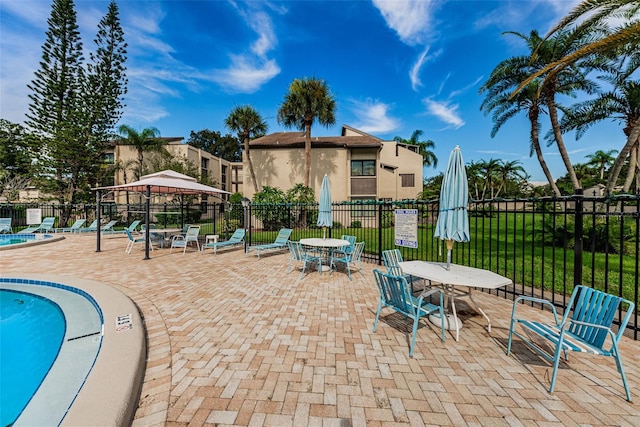 view of patio featuring a gazebo and a community pool