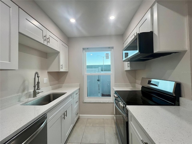 kitchen featuring white cabinets, light stone countertops, sink, and appliances with stainless steel finishes