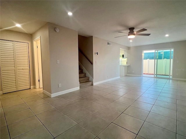 tiled spare room featuring ceiling fan