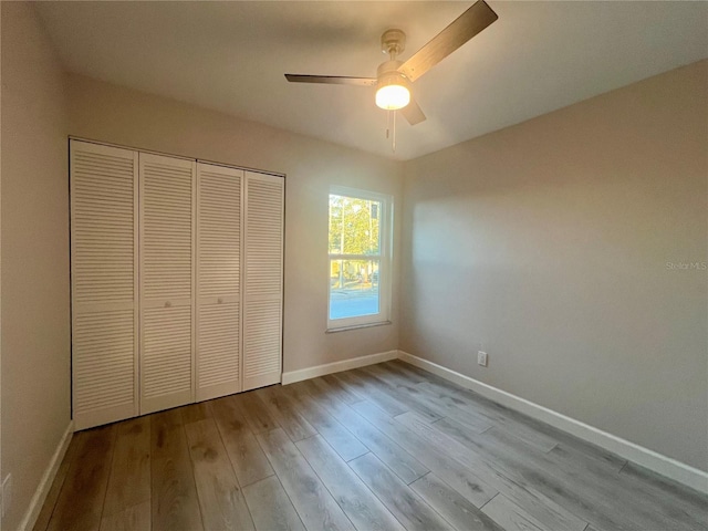 unfurnished bedroom featuring a closet, ceiling fan, and light hardwood / wood-style flooring