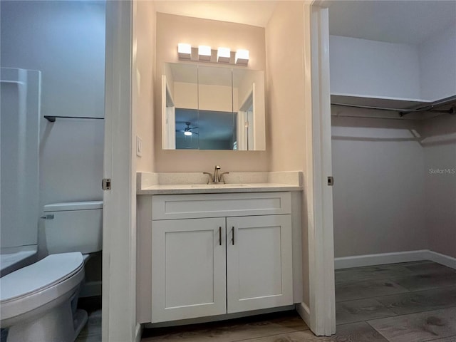 bathroom featuring toilet, vanity, and hardwood / wood-style flooring