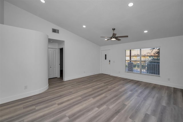 empty room with ceiling fan, light wood-type flooring, and vaulted ceiling