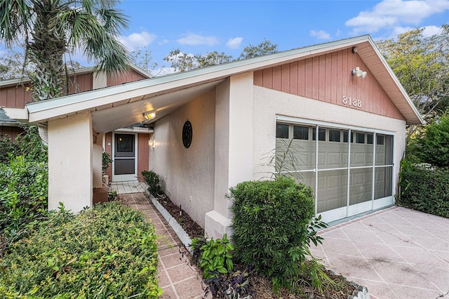 view of exterior entry with a garage