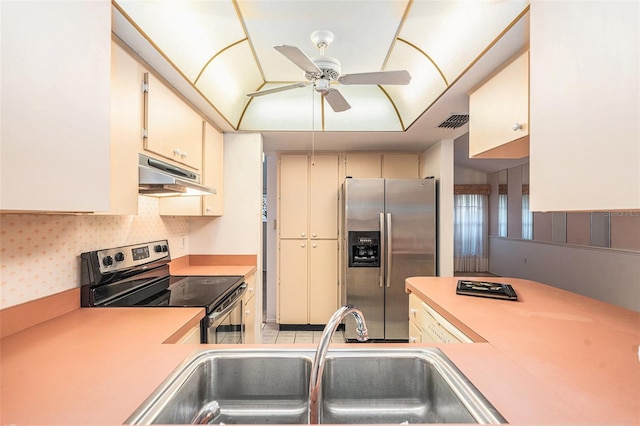 kitchen featuring appliances with stainless steel finishes, ceiling fan, cream cabinets, and sink