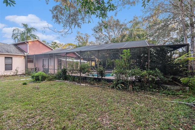 view of yard with glass enclosure