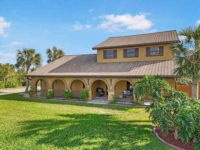 rear view of property featuring a lawn