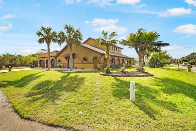 view of front of home with a garage and a front yard