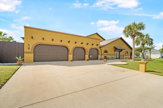 view of front of house with a garage and a front lawn