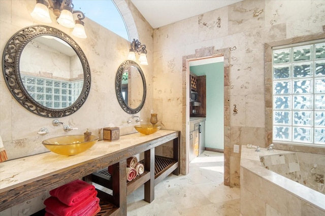 bathroom featuring a bathing tub, tile walls, and vanity