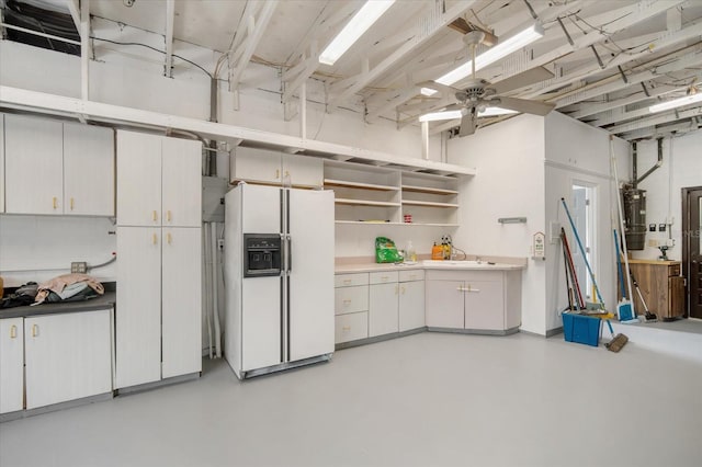 interior space featuring water heater, white fridge with ice dispenser, and ceiling fan