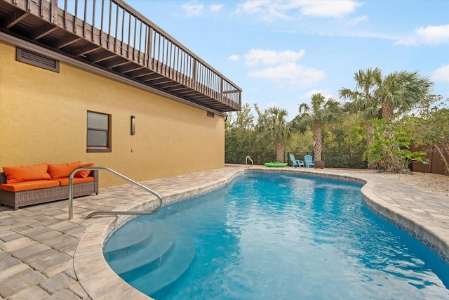 view of pool with an outdoor living space and a patio