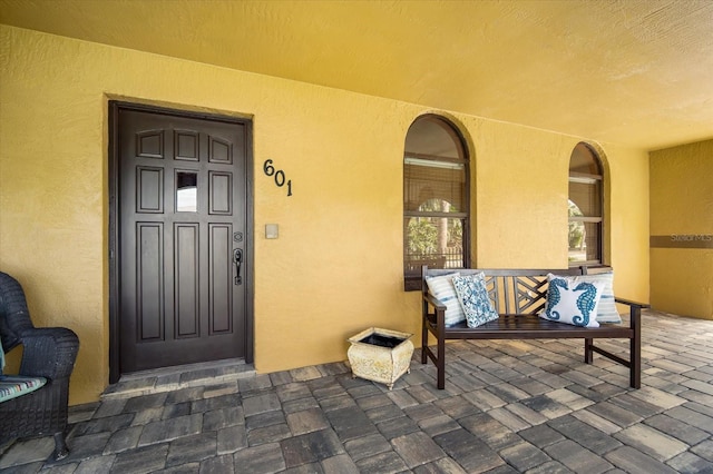 view of exterior entry with covered porch