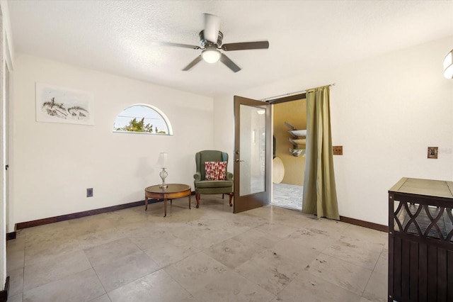 sitting room featuring french doors and ceiling fan