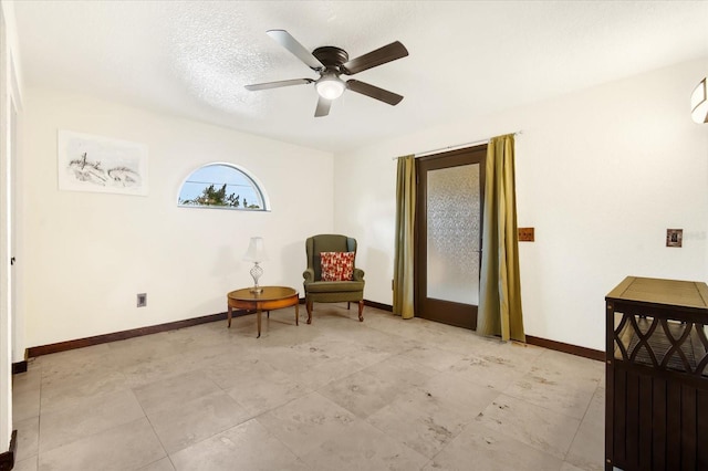 living area with ceiling fan