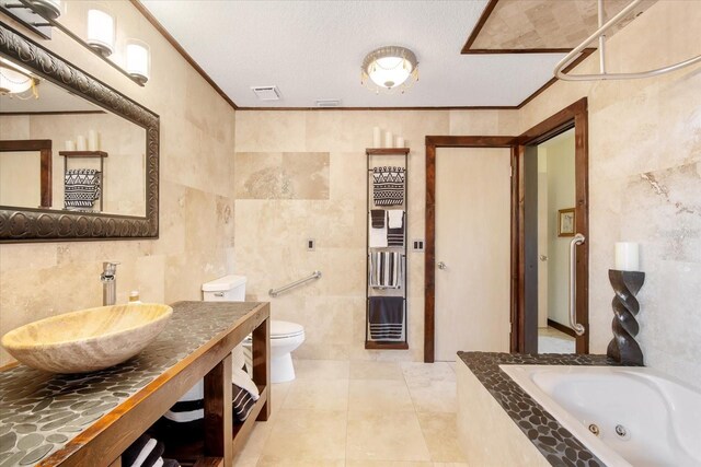 bathroom featuring crown molding, sink, tile walls, and a bathtub