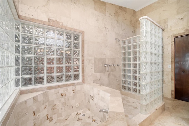 bathroom with a tile shower