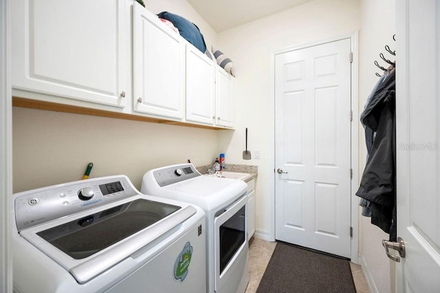 laundry area featuring washer and dryer, light tile patterned floors, cabinets, and sink