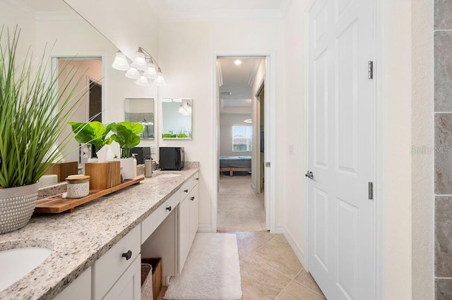 bathroom with tile patterned flooring, vanity, and crown molding