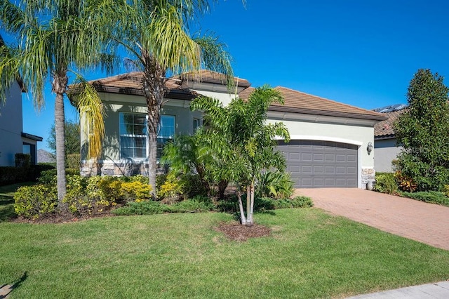 view of front of property featuring a front yard and a garage