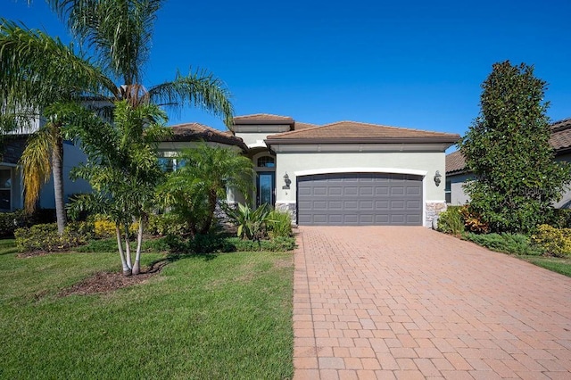 12241 Perennial Pl, Bradenton, FL 34211 - view of front of property featuring an attached garage, a front lawn, decorative driveway, stucco siding, and stone siding