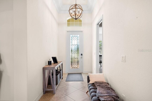 tiled foyer with ornamental molding and a notable chandelier