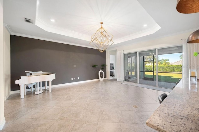 living room with a notable chandelier, crown molding, and a tray ceiling