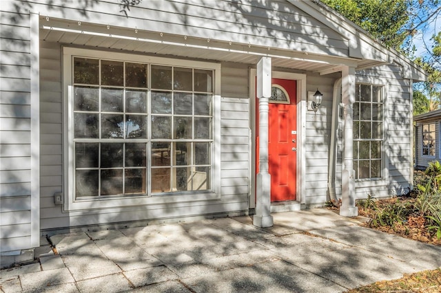 view of exterior entry with a porch