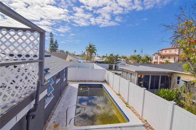 view of swimming pool featuring a sunroom