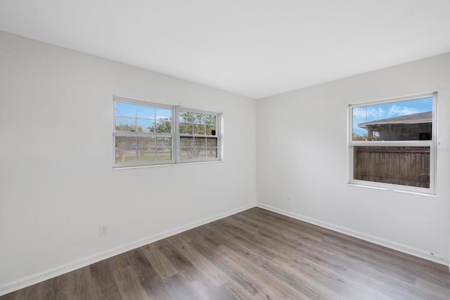 unfurnished room featuring hardwood / wood-style flooring