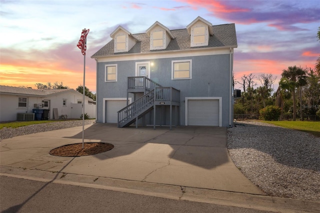 view of front facade featuring a garage and central AC unit