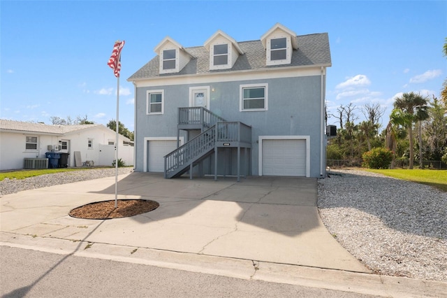 4148 Rudder Way, New Port Richey, FL 34652 - beach home featuring concrete driveway, stairs, a garage, roof with shingles, and stucco siding