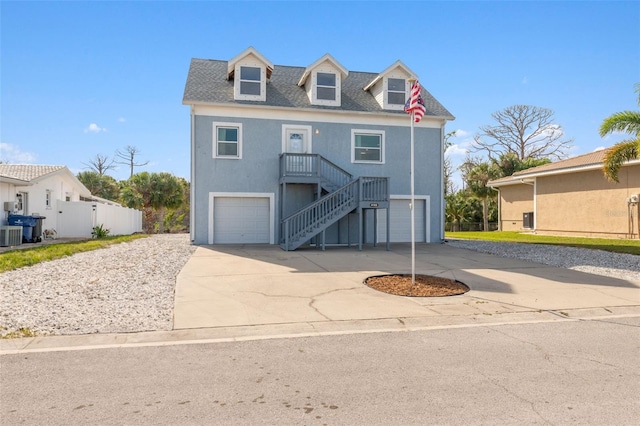 4148 Rudder Way, New Port Richey, FL 34652 - coastal home with an attached garage, concrete driveway, stairs, and central air condition unit
